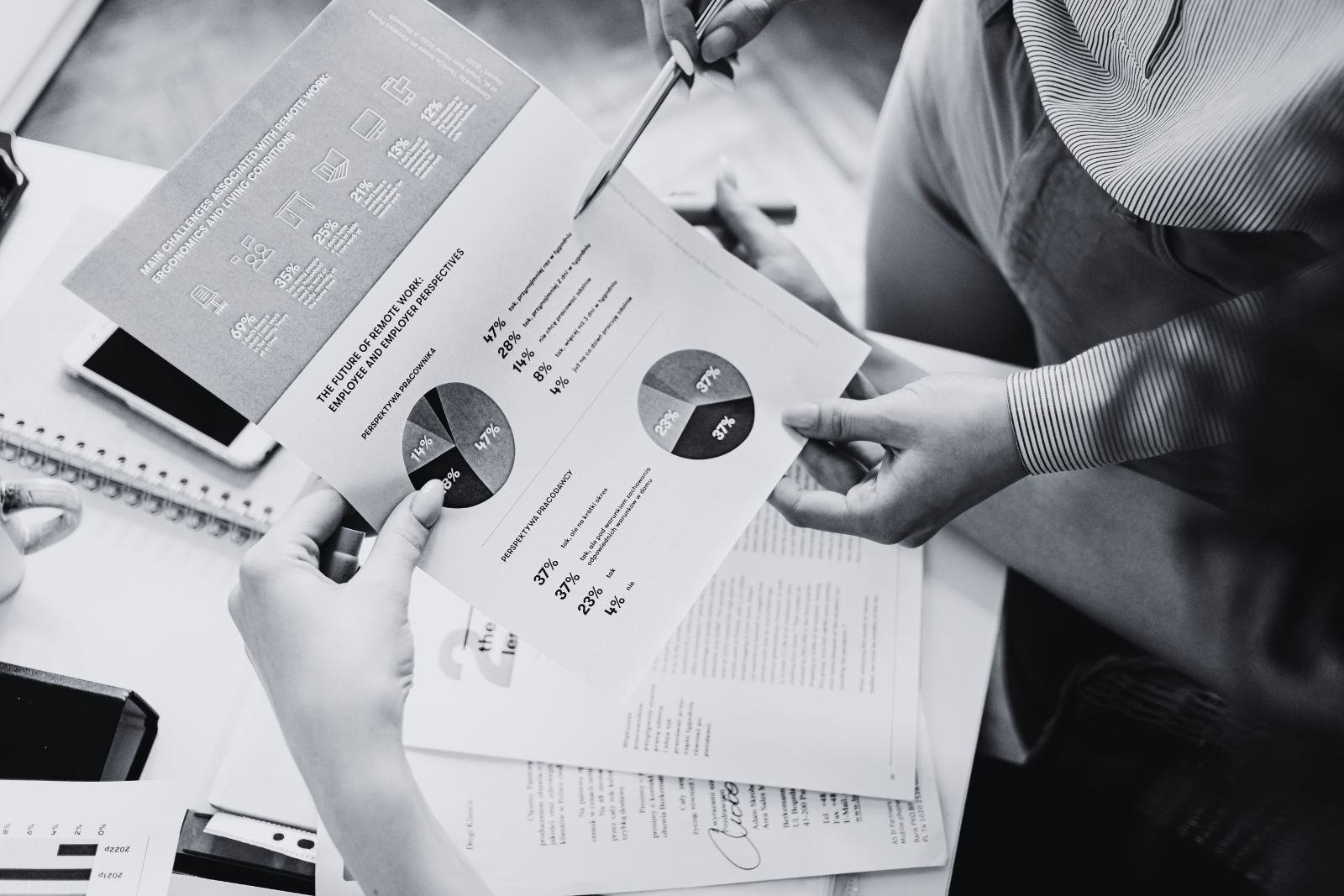 Stacked payroll reports neatly arranged on a desk, representing Payroll Services in a professional corporate workspace.