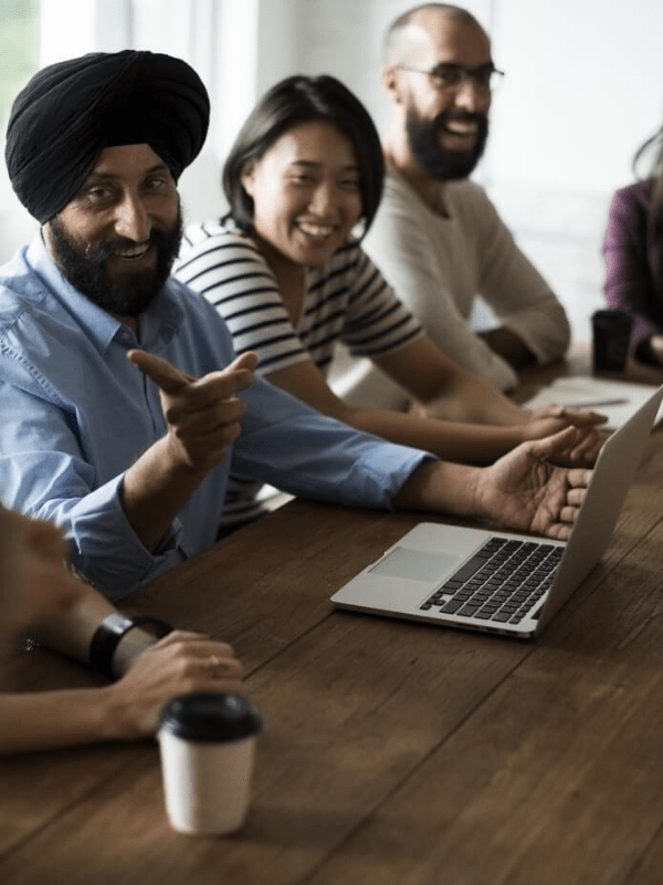 Advisors consulting clients and reviewing HR documents in a professional setting for accurate payroll management services